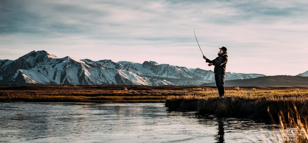 OutdoorHQ-Man-fly-fishing-in-a-clear-river